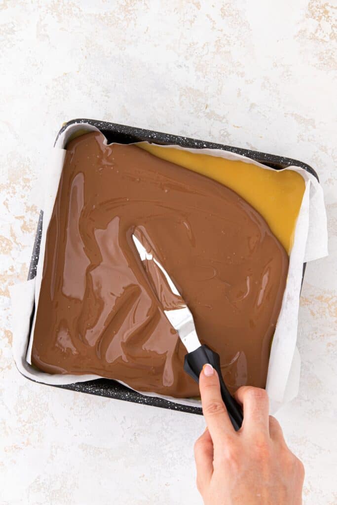 Milk chocolate spread on top of caramel
