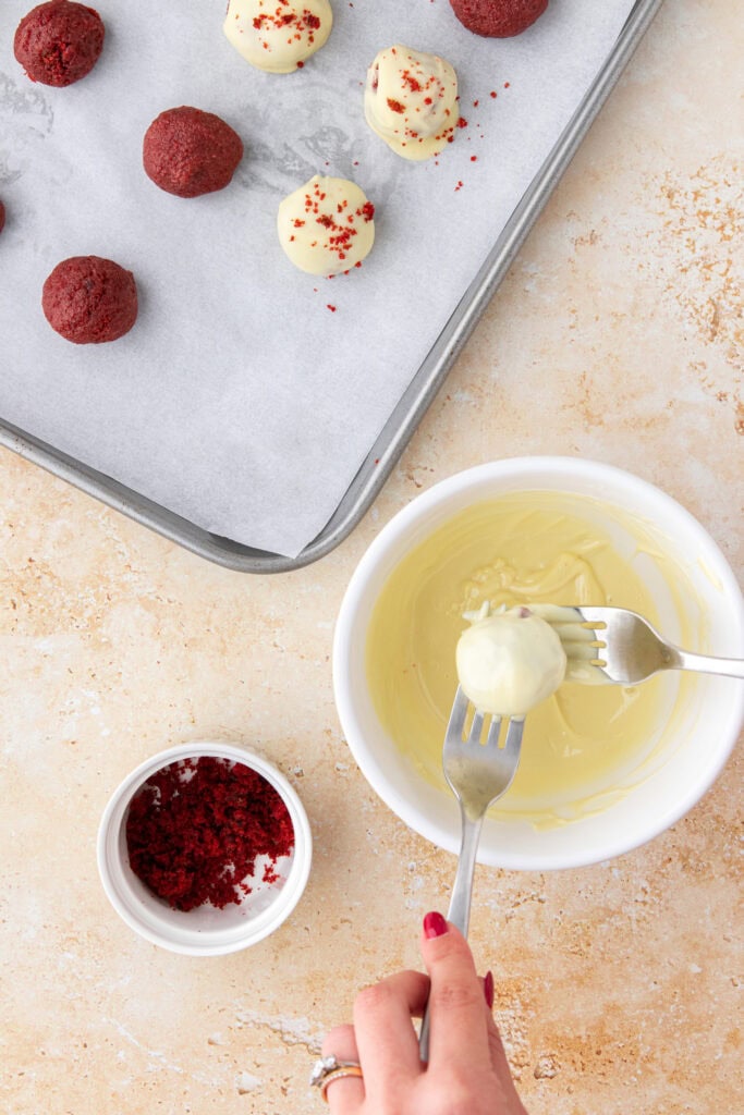 dunking cake truffles in white chocolate