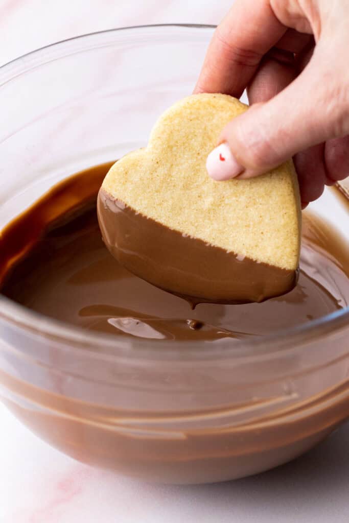 dunking shortbread hearts in chocolate