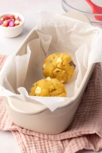 Two balls of cookie dough in a baking dish