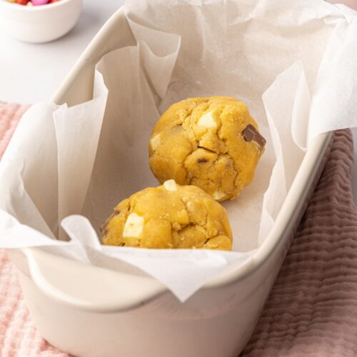 Two balls of cookie dough in a baking dish