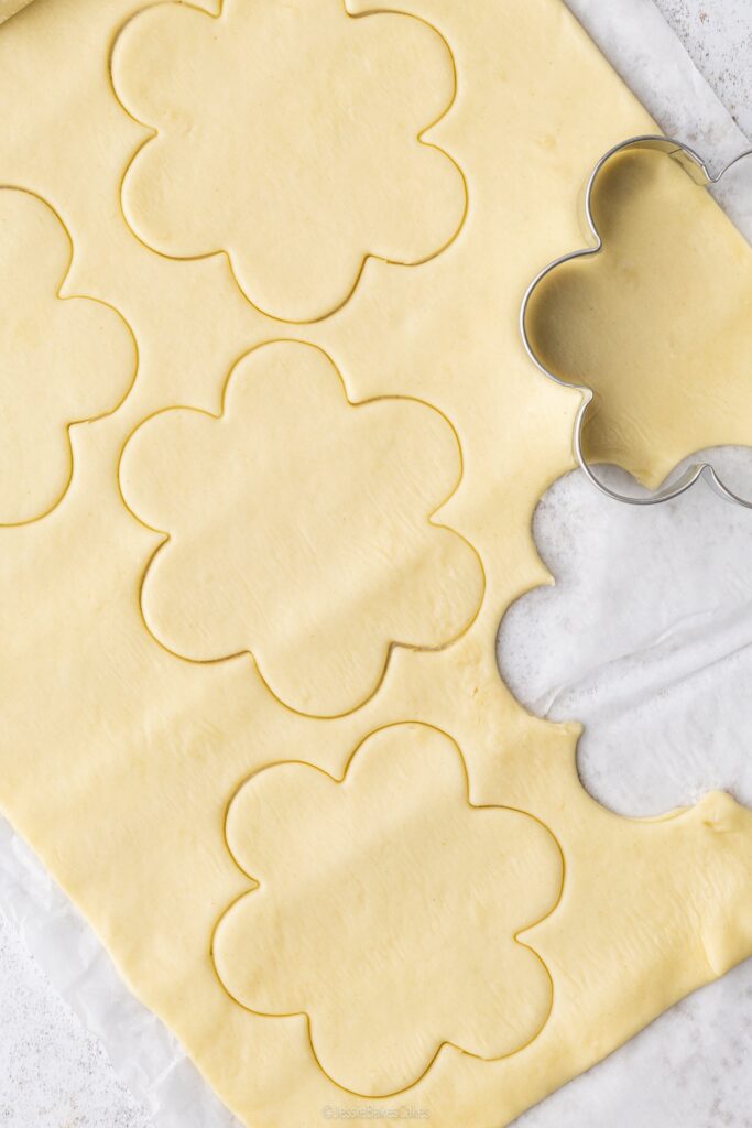 flower shaped cookie cutter stamping out shortcrust pastry