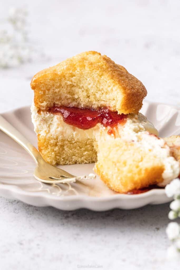 Mini cake on a plate being eaten with a fork
