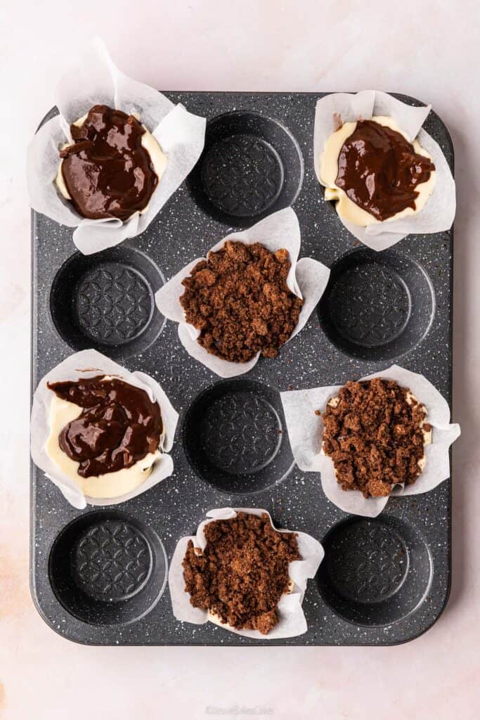 A birds eye view of some chocolate muffins in a baking tray