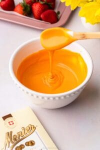 A bowl full of melted white chocolate dyed orange