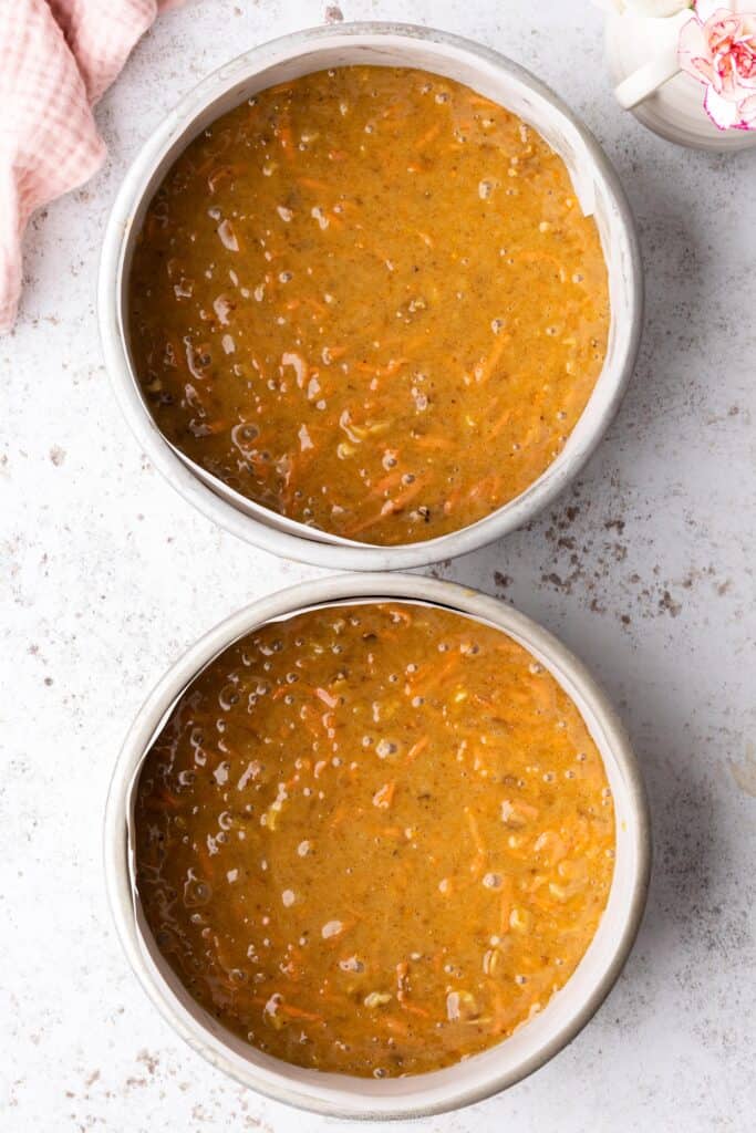 two cake tins filled with cake mixture