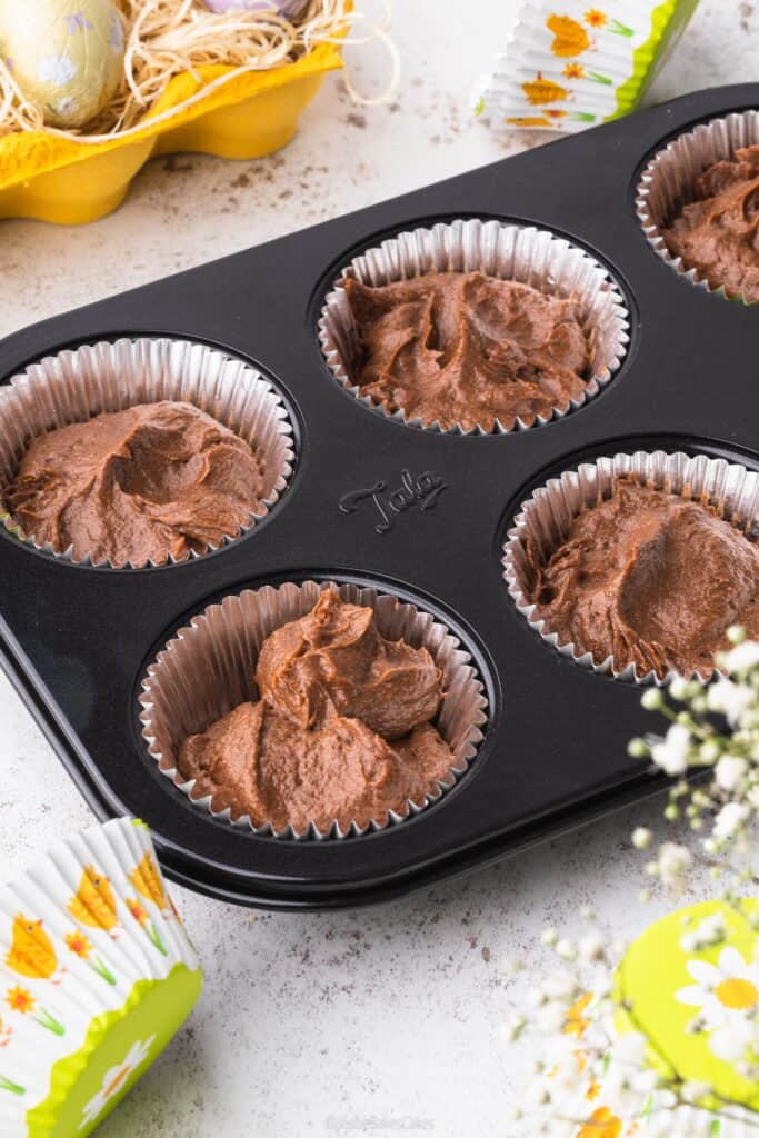tala cupcake tin with chocolate cake mixture and easter cupcake cases