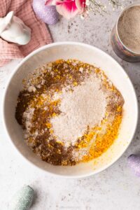 A top down view of some ingredients in a bowl, ready to make a Sticky Toffee Hot Cross Loaf Cake