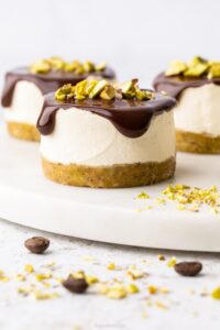 Pistachio and coffee mini cheesecake with a bite missing