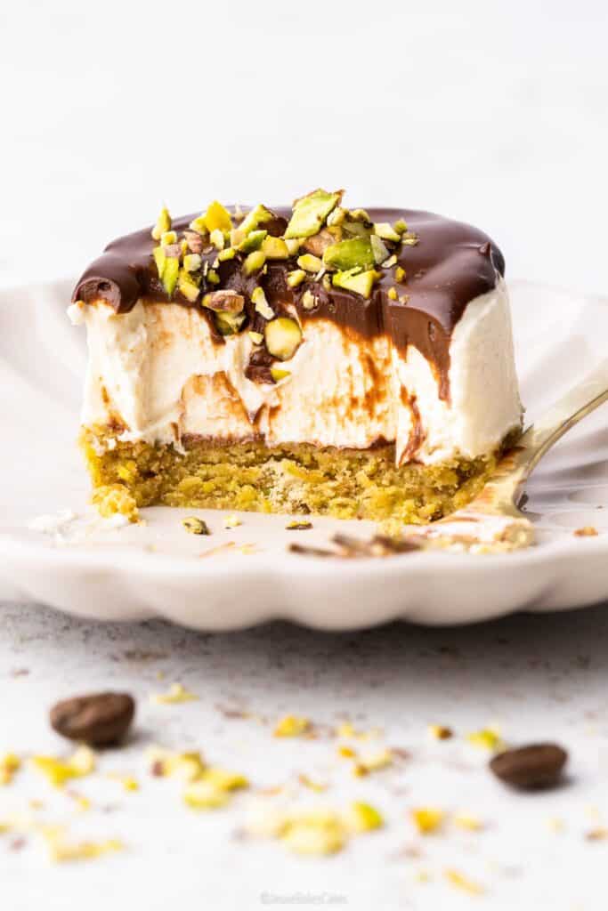 Pistachio and coffee mini cheesecake with a bite missing