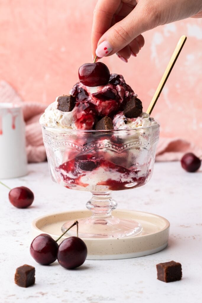 Adding a cherry on top of a Black Forest Ice Cream Sundae