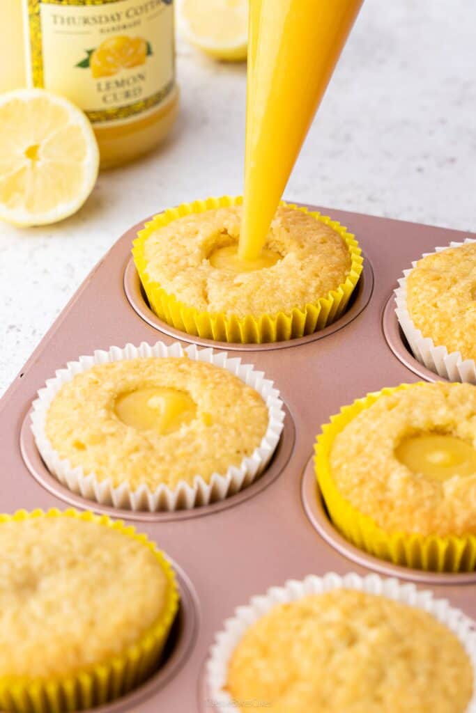 filling a lemon cupcake with lemon curd