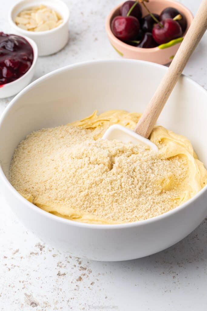 a mixing bowl full of ground almond sponge mixture