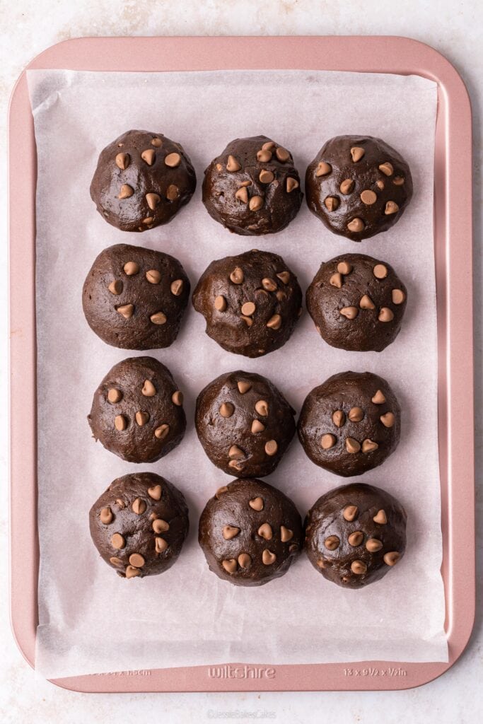 rolled chocolate cookie dough on a baking tray