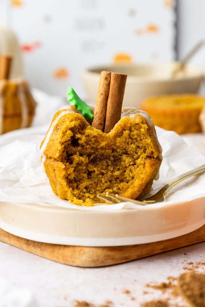 a single Mini Pumpkin Cake on a plate half eaten with a fork