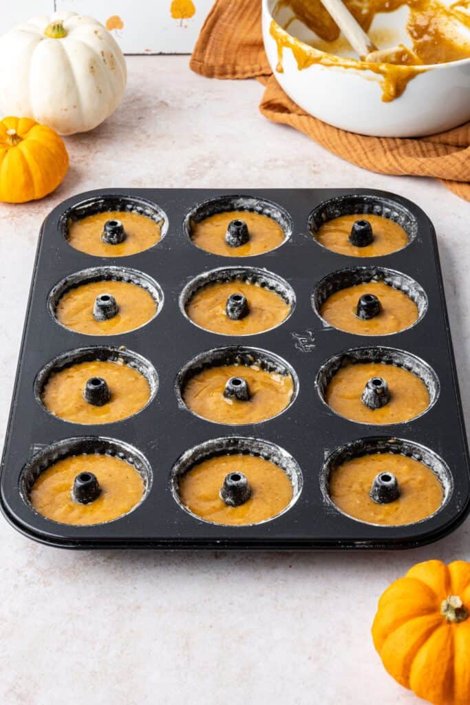 mini bundt tin filled with pumpkin cake mixture