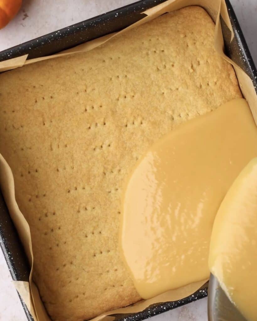 pouring miso caramel over shortbread base