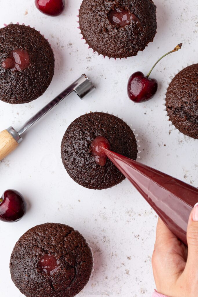 filling mocha cupcakes with cherry purée