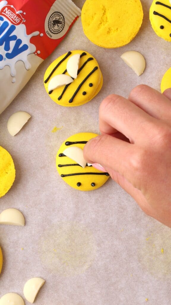 decorating bee macarons with milkybar buttons