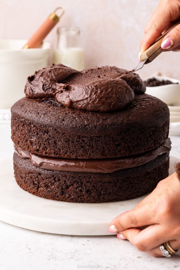 spreading frosting on cake