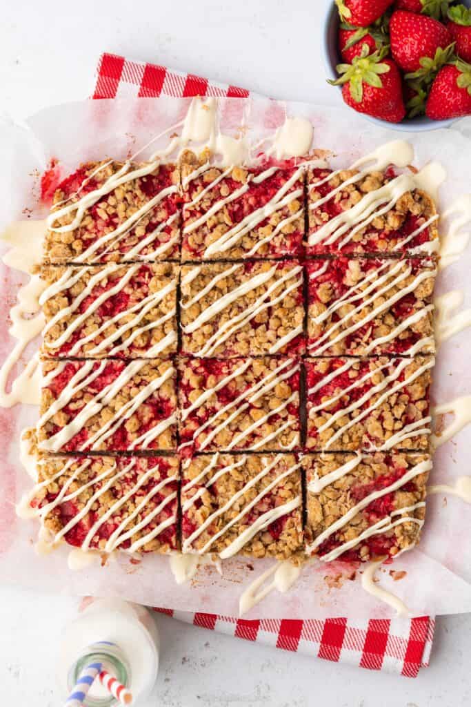 Strawberry Crumble Bars drizzled with milkybar white chocolate