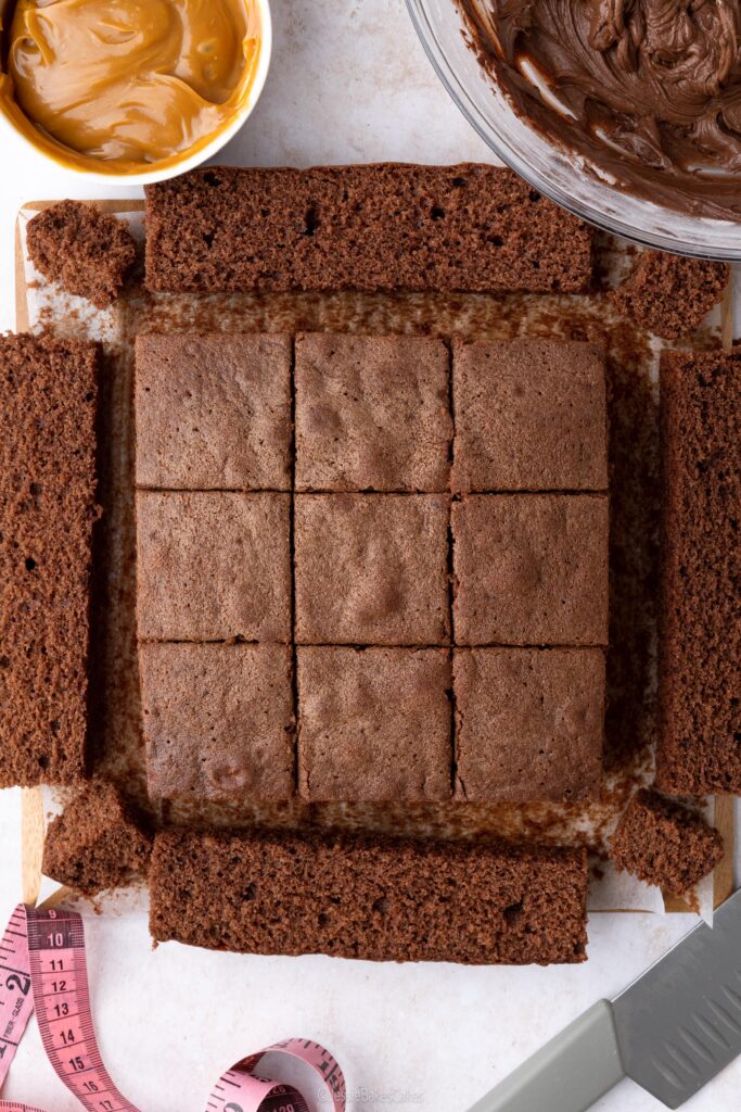 cutting a chocolate sponge to make fondant fancies