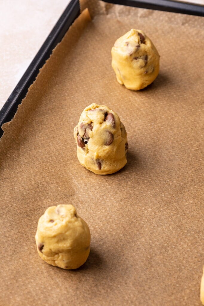 rolled balls of cookie dough on a baking tray